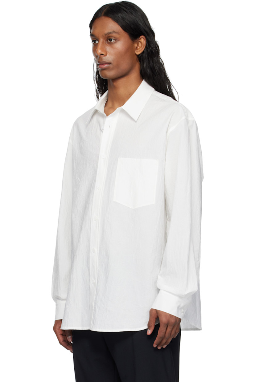 Cotton poplin shirt.

· Spread collar
· Button closure
· Patch pocket
· Shirttail hem
· Buttoned barrel cuffs
· Logo appliqué at back

Supplier color: White