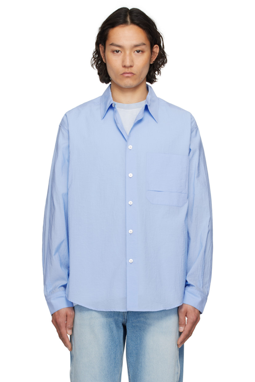 Cotton- and nylon-blend poplin shirt. 

· Spread collar
· Button closure
· Patch pocket at chest
· Shirttail hem
· Single-button barrel cuffs
· Pleats at yoke

Supplier color: Blue