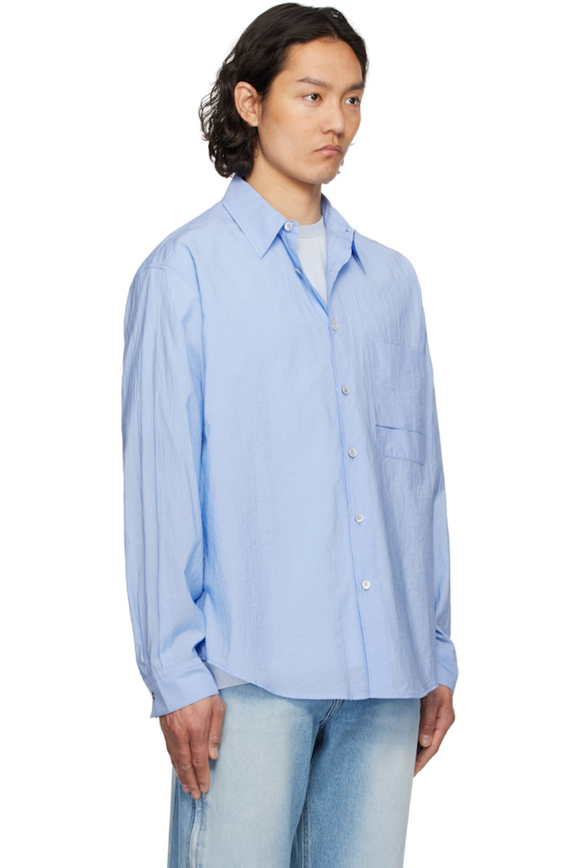 Cotton- and nylon-blend poplin shirt. 

· Spread collar
· Button closure
· Patch pocket at chest
· Shirttail hem
· Single-button barrel cuffs
· Pleats at yoke

Supplier color: Blue