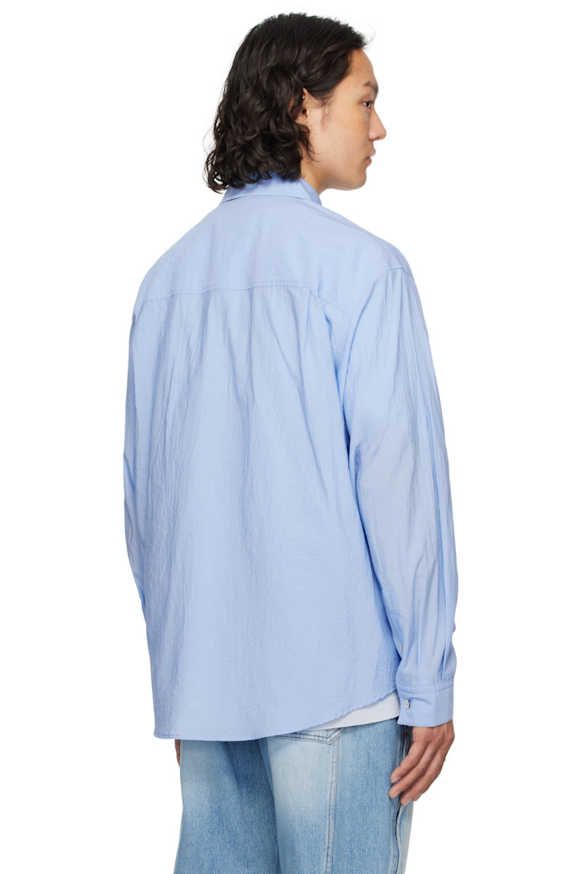 Cotton- and nylon-blend poplin shirt. 

· Spread collar
· Button closure
· Patch pocket at chest
· Shirttail hem
· Single-button barrel cuffs
· Pleats at yoke

Supplier color: Blue