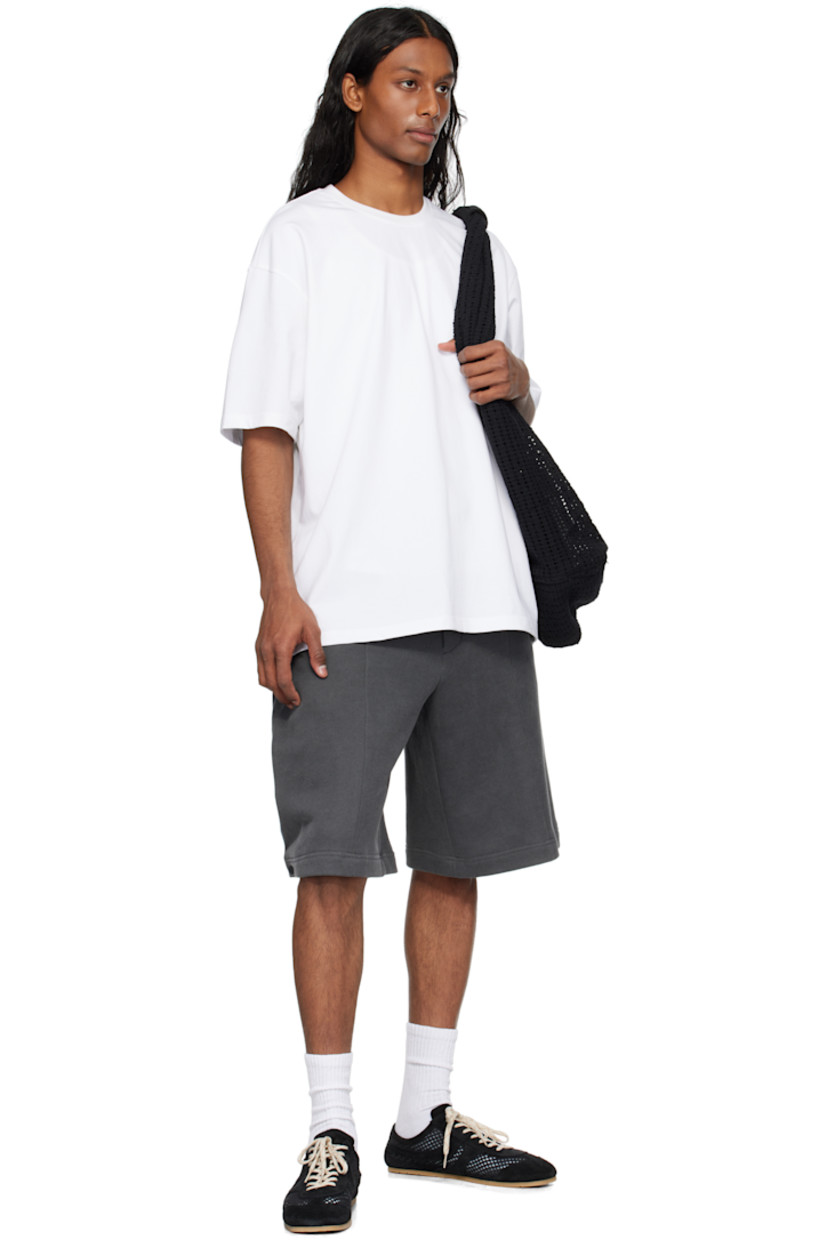 Cotton jersey T-shirt. 

· Rib-knit crewneck
· Logo, graphic, and text embroidered and printed at chest
· Dropped shoulders
· Vented side seams
· Logo graphic printed at back
· Text embroidered at back

Supplier color: White