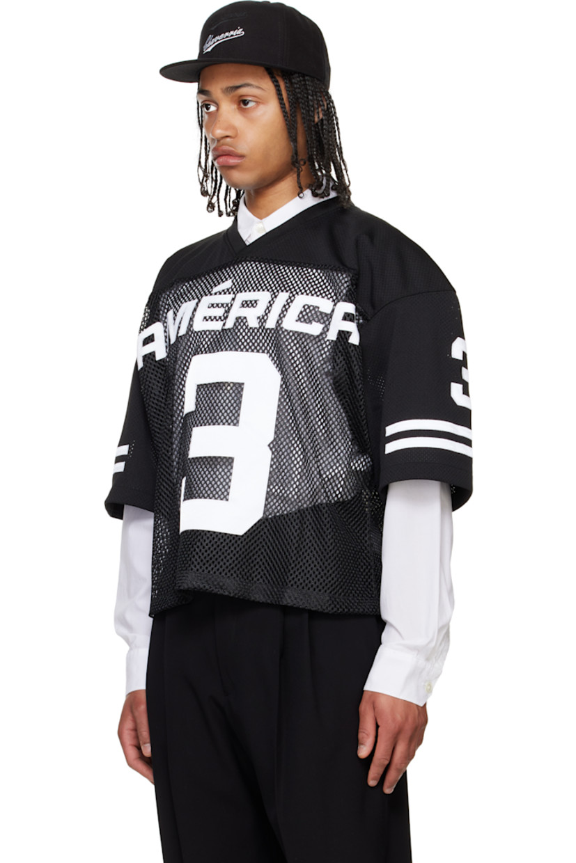 Polyester mesh T-shirt.

· Paneled construction
· Rib-knit V-neck
· Text appliqués at front, sleeves, and back
· Dropped shoulders
· Stripe appliqués at sleeves
· Embroidered logo patch at back collar

Supplier color: Black