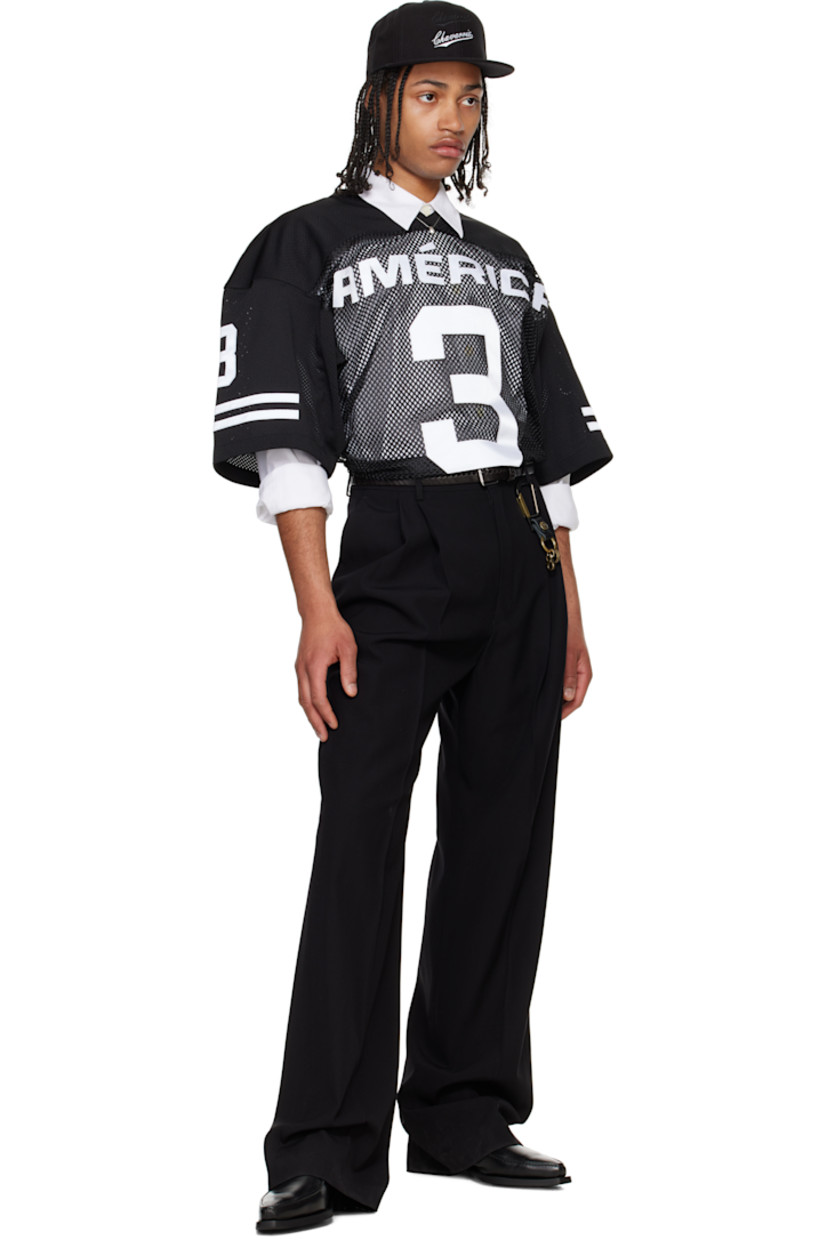 Polyester mesh T-shirt.

· Paneled construction
· Rib-knit V-neck
· Text appliqués at front, sleeves, and back
· Dropped shoulders
· Stripe appliqués at sleeves
· Embroidered logo patch at back collar

Supplier color: Black