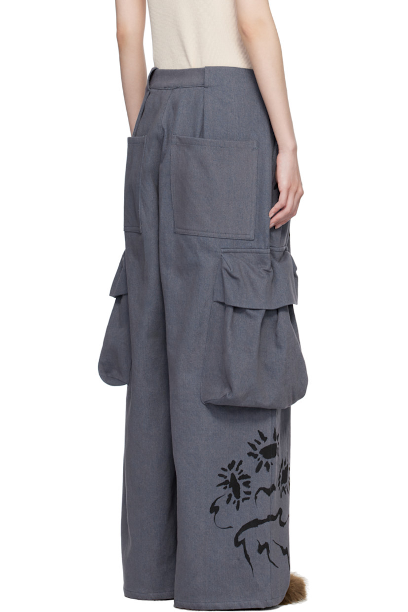 Hand-dyed non-stretch denim cargo pants. Hand-painted floral graphic throughout.

· Mid-rise
· Belt loops
· Four-pocket styling
· Zip-fly
· Pleats and gathering at front
· Bellows pocket at outseams

Supplier color: Charcoal daisy