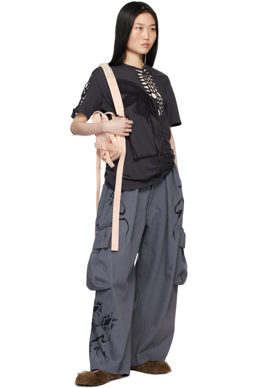 Hand-dyed non-stretch denim cargo pants. Hand-painted floral graphic throughout.

· Mid-rise
· Belt loops
· Four-pocket styling
· Zip-fly
· Pleats and gathering at front
· Bellows pocket at outseams

Supplier color: Charcoal daisy