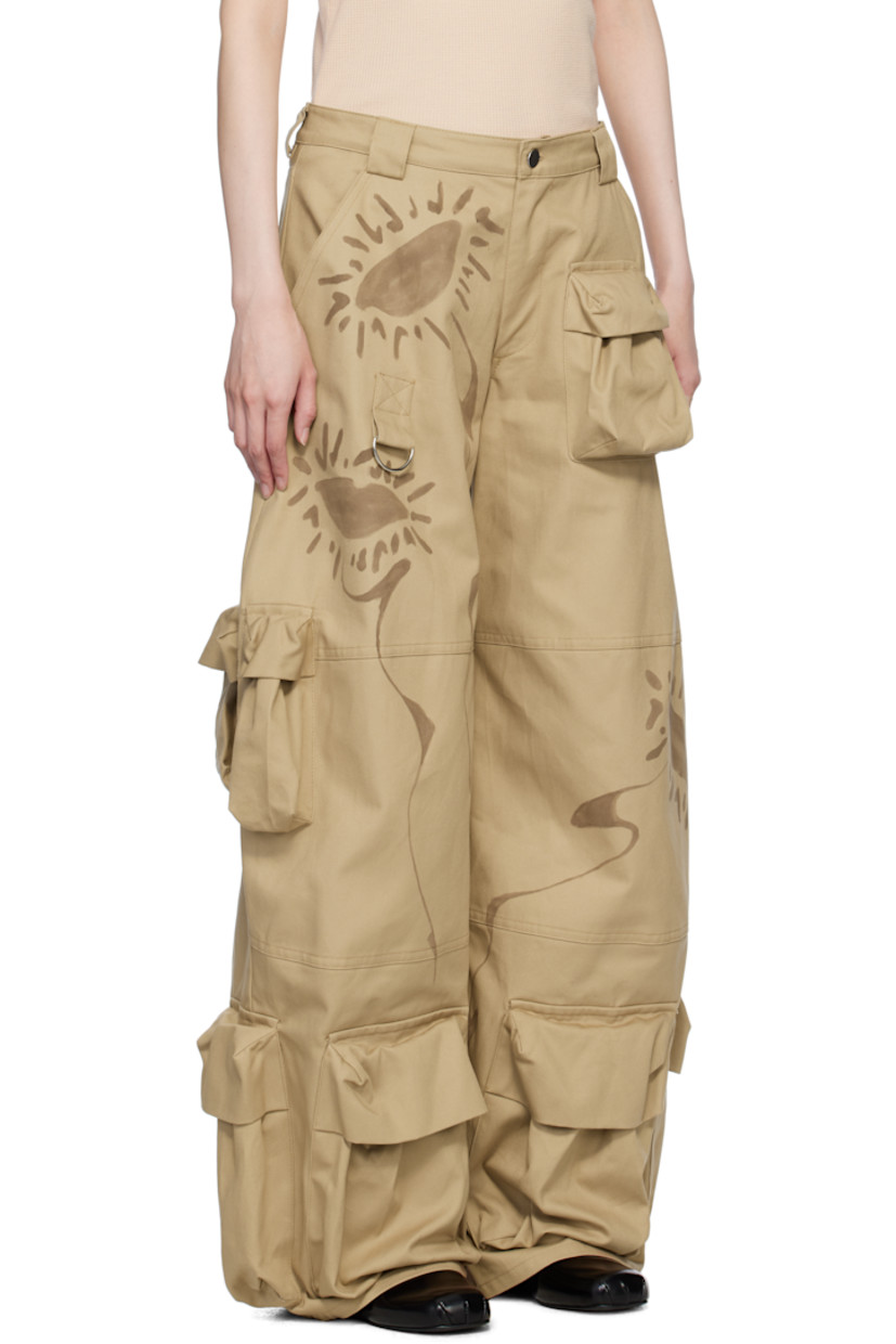 Relaxed-fit and hand-dyed cotton twill cargo pants. Hand-painted floral graphics throughout.

· Wide-leg 
· Mid-rise
· Belt loops
· Five-pocket styling
· Zip-fly
· Bellows pockets at legs
· D-ring at front

Supplier color: Sand daisy