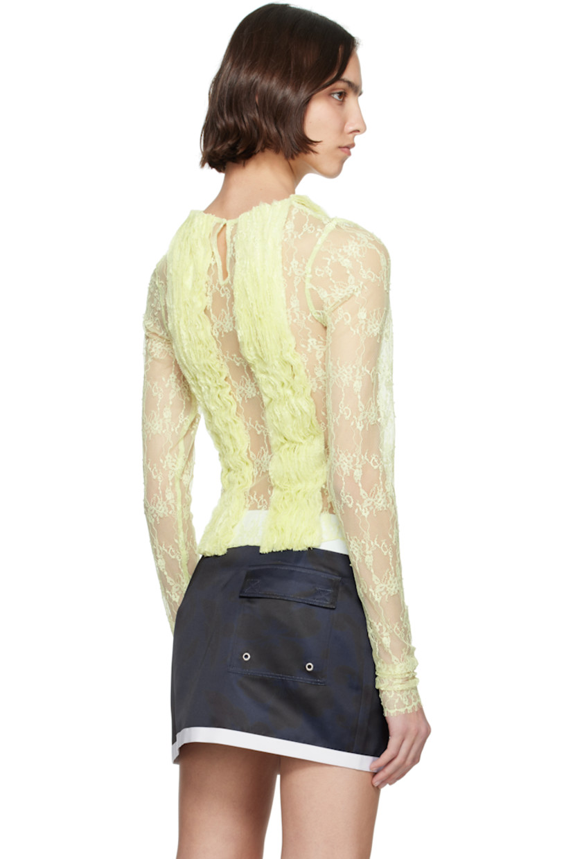 Sheer nylon- and recycled nylon-blend lace top. Ruffled trim and embroidered floral pattern throughout.

· Round neck
· Fringed detailing at hem and cuffs
· Zip closure at side seam
· Hook-eye fastening at keyhole back

Supplier color: Celery