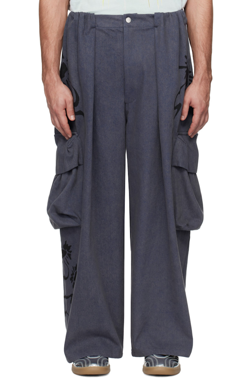 Hand-dyed non-stretch denim cargo pants. Hand-painted floral graphics throughout.

· Mid-rise
· Belt loops
· Four-pocket styling
· Zip-fly
· Pleats at front and back
· Gathering at front
· Bellows pocket at outseams

Each item is unique. Please note that coloration may vary.

Supplier color: Charcoal daisy