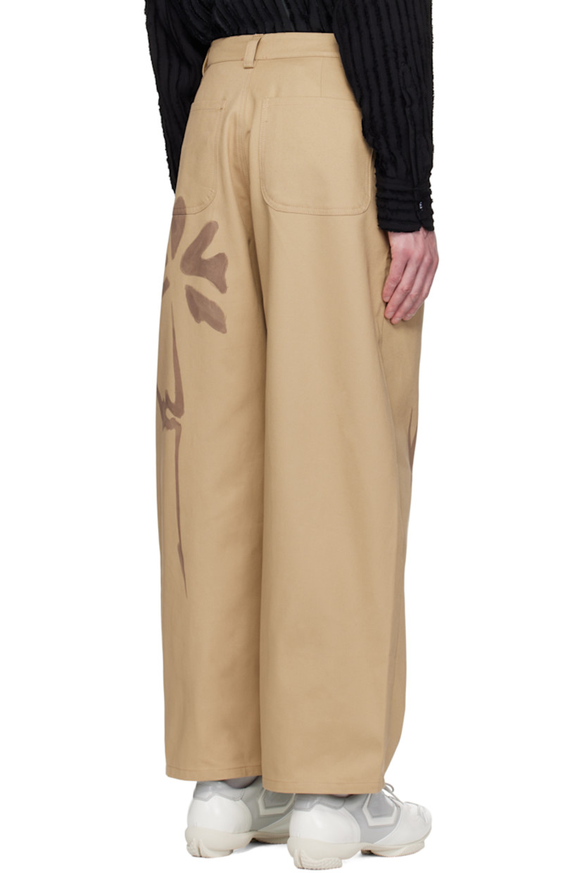 Hand-dyed organic cotton twill trousers. 

· Mid-rise
· Belt loops
· Four-pocket styling
· Zip fly
· Pleats at front
· Hand-painted floral graphics at front and back

Each item is unique. Please note coloration may vary.

Supplier color: Sand