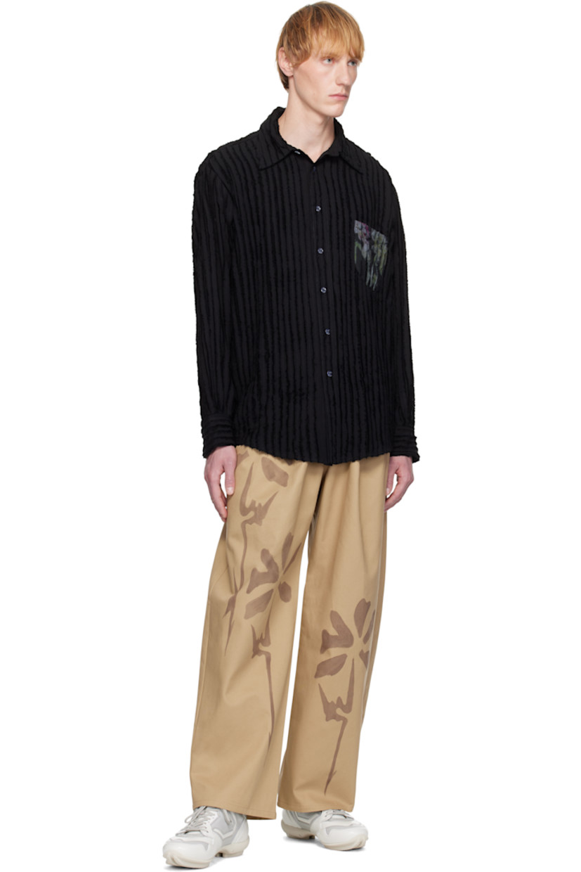 Hand-dyed organic cotton twill trousers. 

· Mid-rise
· Belt loops
· Four-pocket styling
· Zip fly
· Pleats at front
· Hand-painted floral graphics at front and back

Each item is unique. Please note coloration may vary.

Supplier color: Sand