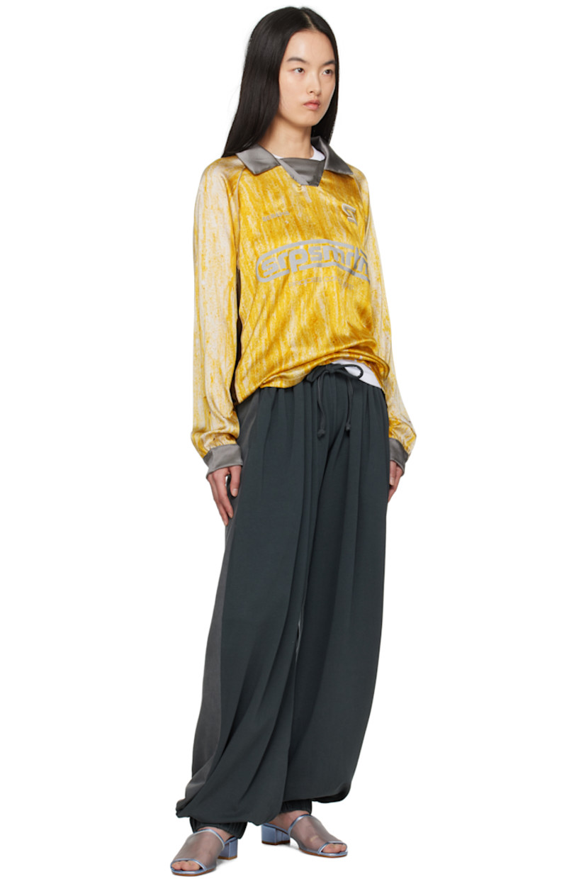 Stretch silk satin polo. Graphic pattern printed throughout.

· Spread collar
· Logos embroidered at chest
· Logo and text bonded at front
· Piping at raglan sleeves 

Supplier color: Print