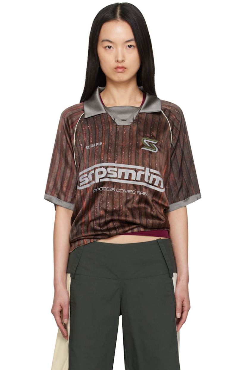 Stretch silk satin polo. Stripe pattern printed throughout.

· Spread collar
· Open placket
· Logos embroidered at chest
· Logo and text bonded at front
· Piping at raglan sleeves 

Supplier color: Print