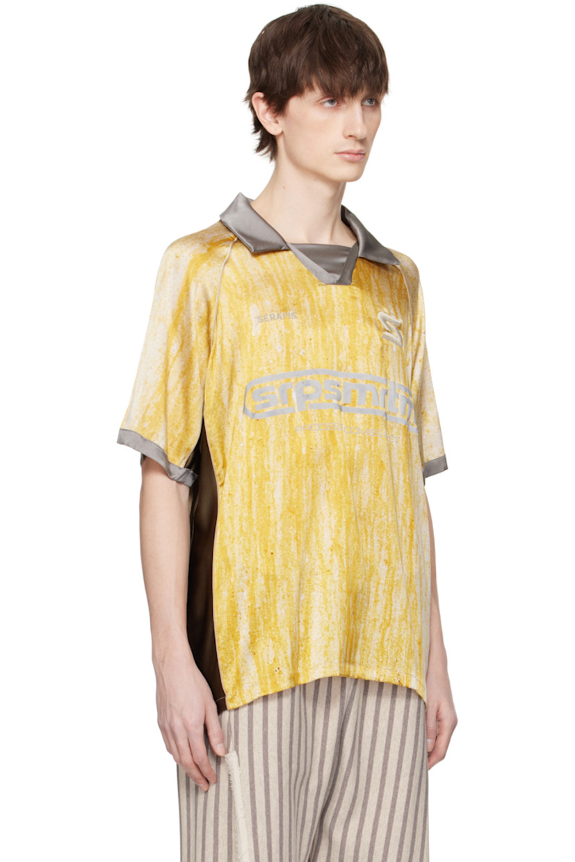 Stretch silk satin polo. Piping and printed graphic pattern throughout.

· Spread collar
· Open placket
· Embroidered logos and printed text at front
· Raglan sleeves

Supplier color: Yellow