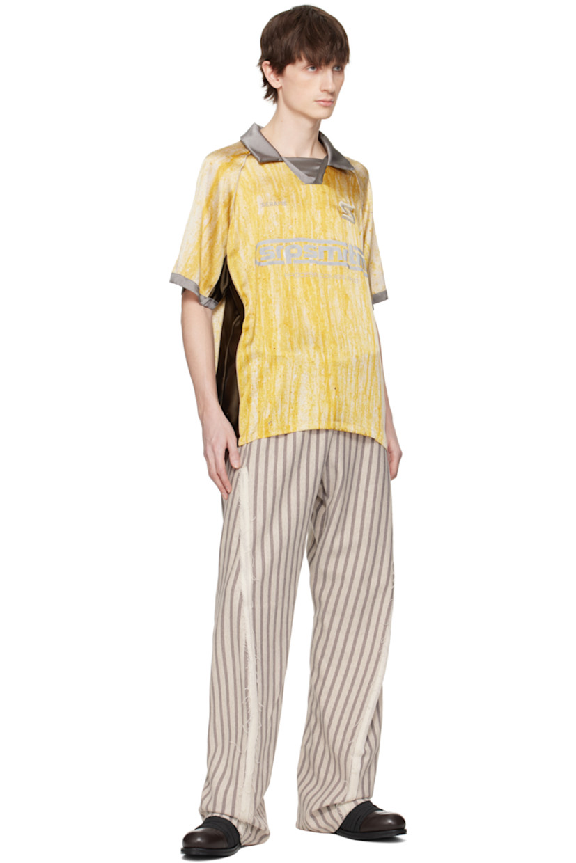 Stretch silk satin polo. Piping and printed graphic pattern throughout.

· Spread collar
· Open placket
· Embroidered logos and printed text at front
· Raglan sleeves

Supplier color: Yellow