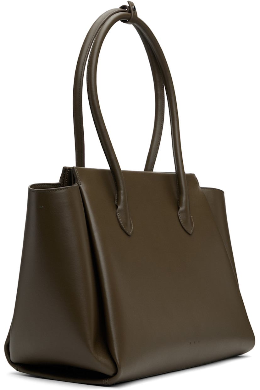 Structured buffed calfskin top handle bag in khaki.

· Post-stud tab at rolled carry handles
· Padded panel at face and back face
· Logo embossed at face
· Bumper studs at base
· Magnetic closure
· Patch pocket at interior
· Twill lining
· H11" x W17" x D7"

Supplier color: Khaki