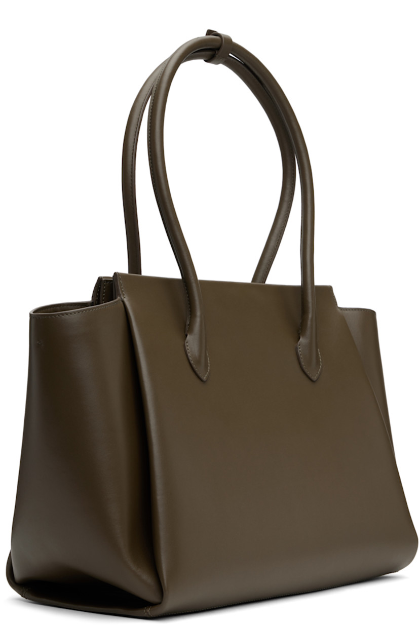 Structured buffed calfskin top handle bag in khaki.

· Post-stud tab at rolled carry handles
· Padded panel at face and back face
· Logo embossed at face
· Bumper studs at base
· Magnetic closure
· Patch pocket at interior
· Twill lining
· H11" x W17" x D7"

Supplier color: Khaki