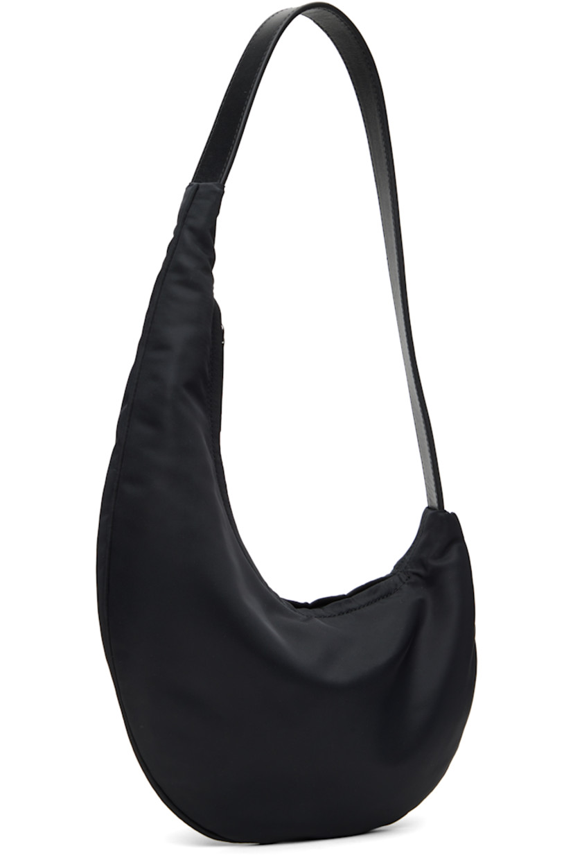 Nylon twill shoulder bag in black.

· Fixed shoulder strap
· Zip closure
· Card slot at interior
· Twill lining
· H13" x W10.5" x D1"

Supplier color: Black