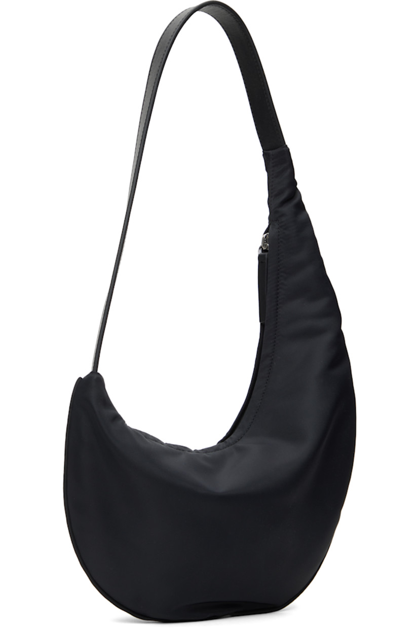 Nylon twill shoulder bag in black.

· Fixed shoulder strap
· Zip closure
· Card slot at interior
· Twill lining
· H13" x W10.5" x D1"

Supplier color: Black