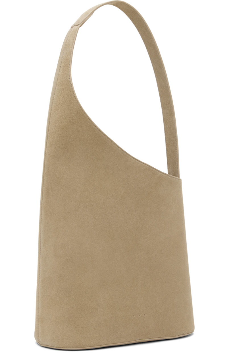 Calfskin suede tote in beige.

· Fixed shoulder strap
· Logo embossed at face
· Magnetic closure
· Patch pocket at interior
· Buffed faux-leather lining
· H10.5" x W11" x D5"
· Total height: H20.5"

Supplier color: Suede sand