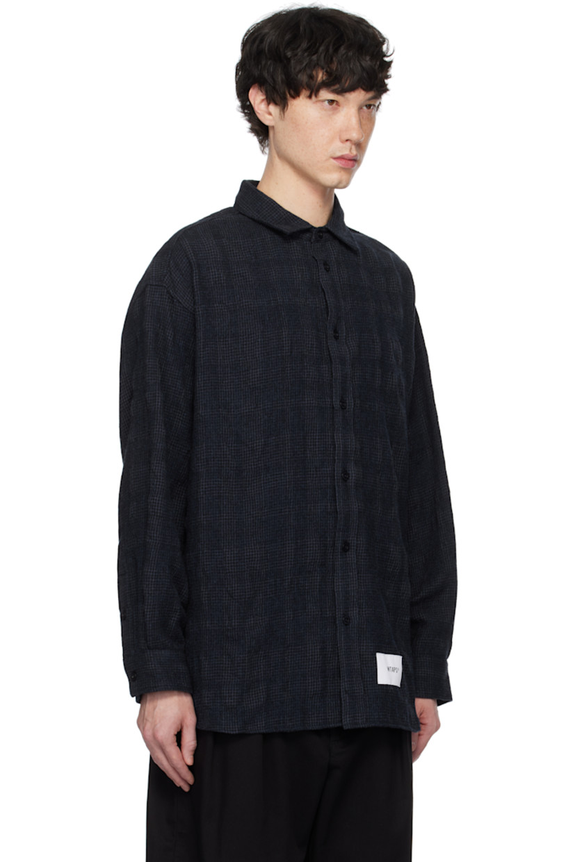 Wool- and cotton-blend flannel shirt. Check pattern throughout.

· Spread collar
· Button closure
· Logo patch at front hem
· Shirttail hem 
· Adjustable single-button barrel cuffs

Supplier color: Navy