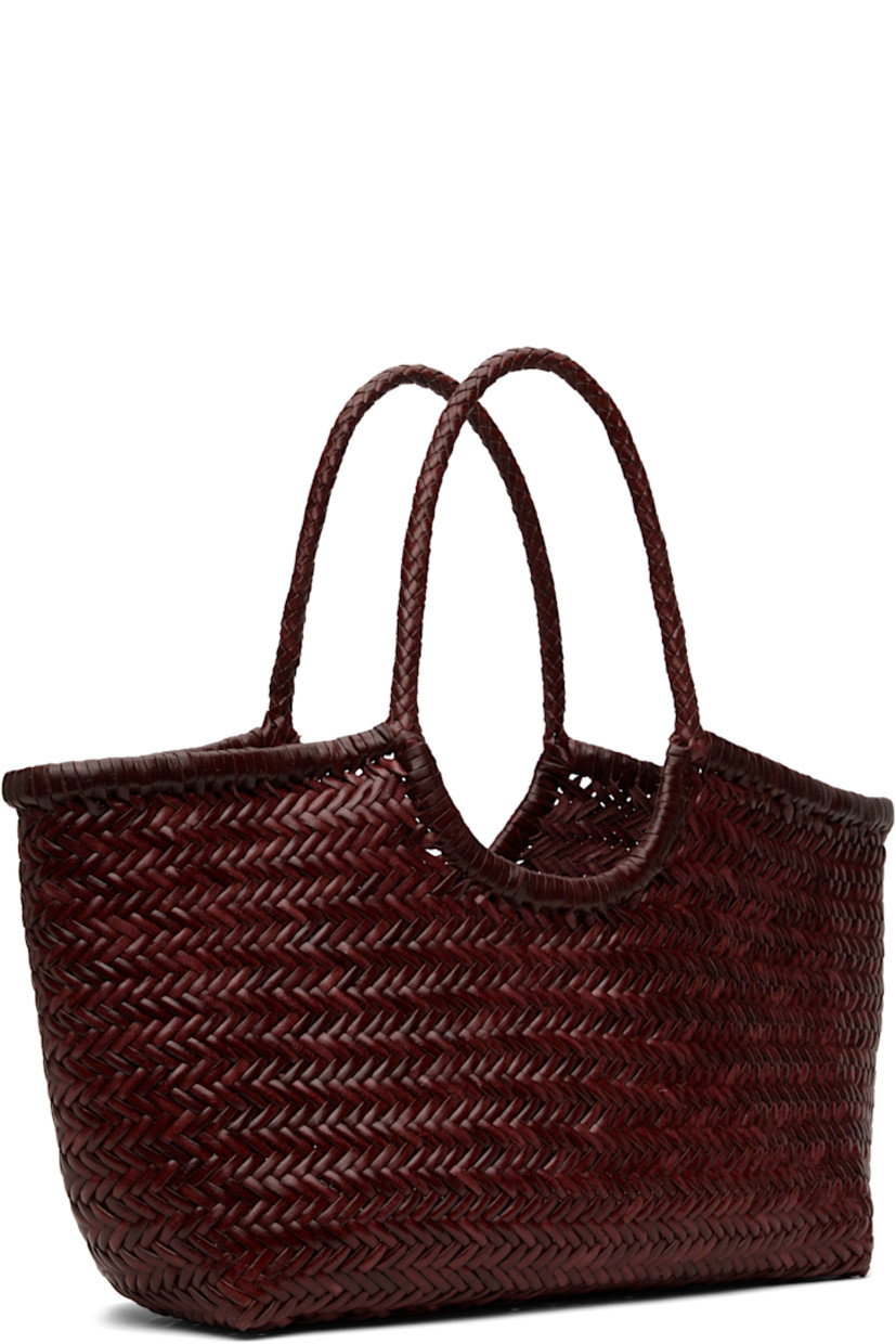 Hand-woven buffalo calfskin top handle bag in burgundy.

· Twin carry handles
· Open throat
· Hand-sewn logo disc at interior
· Unlined
· H9.5" x W19" x D6"
· Total height: H17"

Supplier color: Bordo