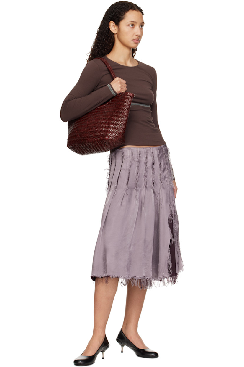 Hand-woven buffalo calfskin top handle bag in burgundy.

· Twin carry handles
· Open throat
· Hand-sewn logo disc at interior
· Unlined
· H9.5" x W19" x D6"
· Total height: H17"

Supplier color: Bordo