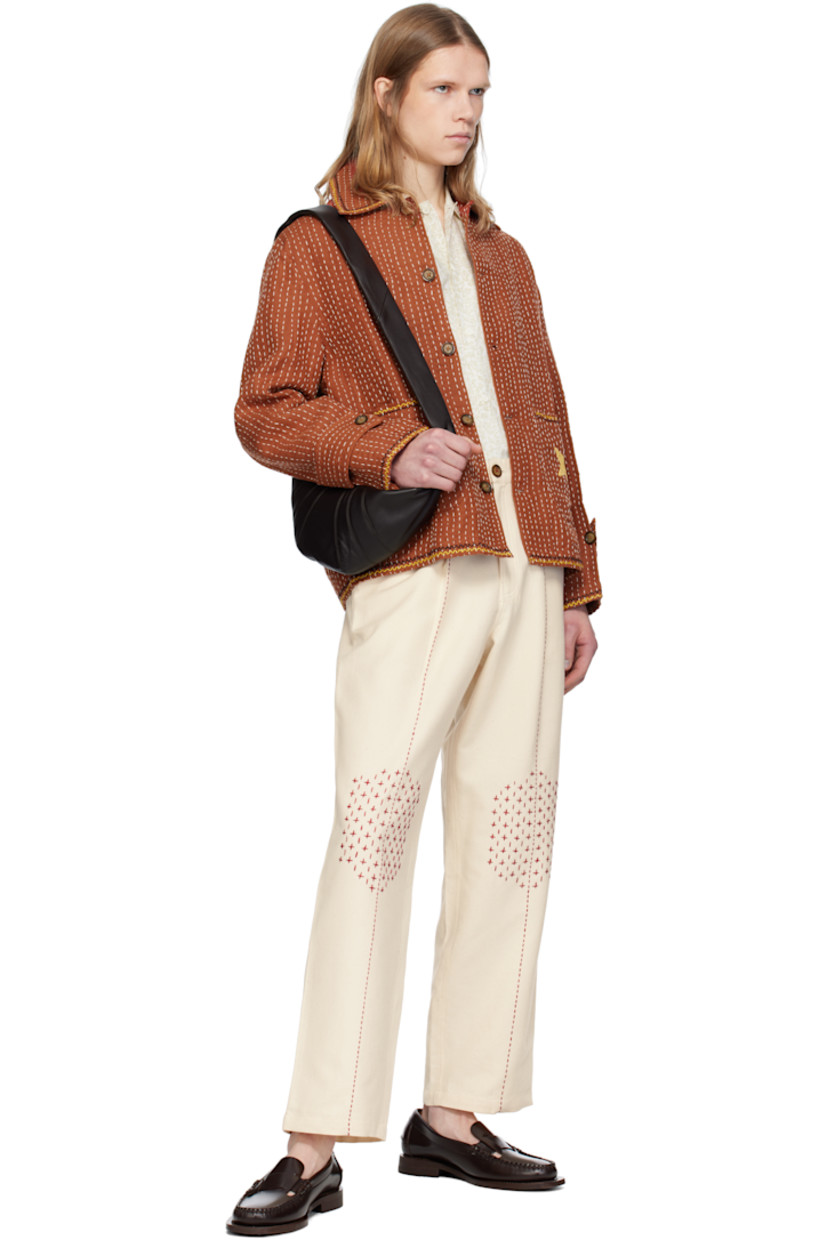 Hand-woven linen hopsack jacket. Stripes embroidered throughout. 

· Spread collar
· Button closure
· Graphic appliqués at front and back
· Patch pockets 
· Adjustable button tab at cuffs

Supplier color: Brown
