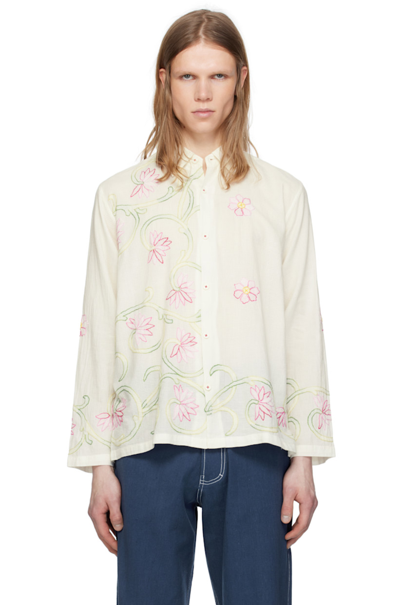 Hand-woven semi-sheer cotton double gauze shirt. Floral graphic pattern embroidered throughout. 

· Spread collar 
· Button closure
· Buttoned barrel cuffs

Supplier color: White