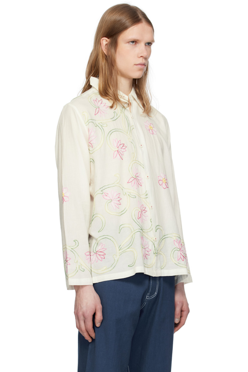 Hand-woven semi-sheer cotton double gauze shirt. Floral graphic pattern embroidered throughout. 

· Spread collar 
· Button closure
· Buttoned barrel cuffs

Supplier color: White