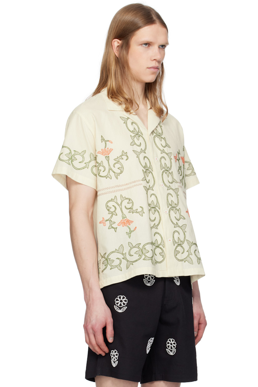 Hand-spun and hand-woven cotton hopsack shirt. Graphic pattern embroidered throughout.

· Boxy-fit
· Open spread collar
· Button closure

Supplier color: Off white