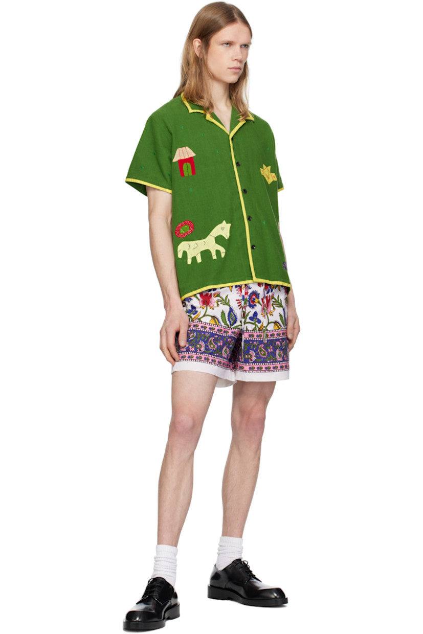 Hand-woven and hand-spun plain-woven cotton shorts. Floral graphic pattern printed throughout. 

· Drawstring at elasticized waistband
· Mock fly 
· Three-pocket styling

Supplier color: White