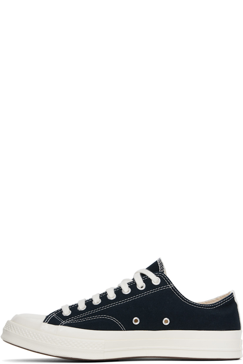 Low-top canvas sneakers in black.

· Rubber cap toe
· Lace-up closure
· Logo printed at outer side
· Metal eyelet vents at inner side
· Webbing trim at heel
· Rubberized logo patch at heel
· Cushioned Ortholite® footbed
· Treaded rubber sole

Part of the Comme des Garçons Play x Converse collaboration.

Supplier color: Black
