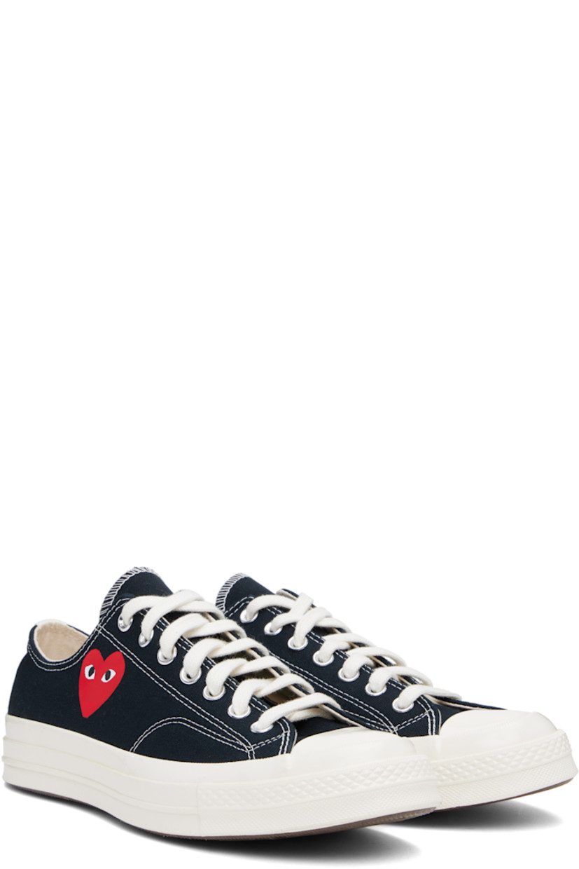 Low-top canvas sneakers in black.

· Rubber cap toe
· Lace-up closure
· Logo printed at outer side
· Metal eyelet vents at inner side
· Webbing trim at heel
· Rubberized logo patch at heel
· Cushioned Ortholite® footbed
· Treaded rubber sole

Part of the Comme des Garçons Play x Converse collaboration.

Supplier color: Black