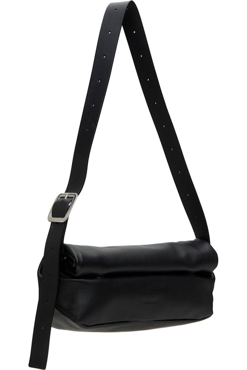 Buffed calfskin belt bag in black.

· Adjustable and detachable crossbody strap
· Logo embossed at face
· Magnetic rolltop closure
· Zip pocket at interior
· Nappa leather lining
· Silver-tone hardware
· H5" x W12.5" x D4"

Supplier color: Black