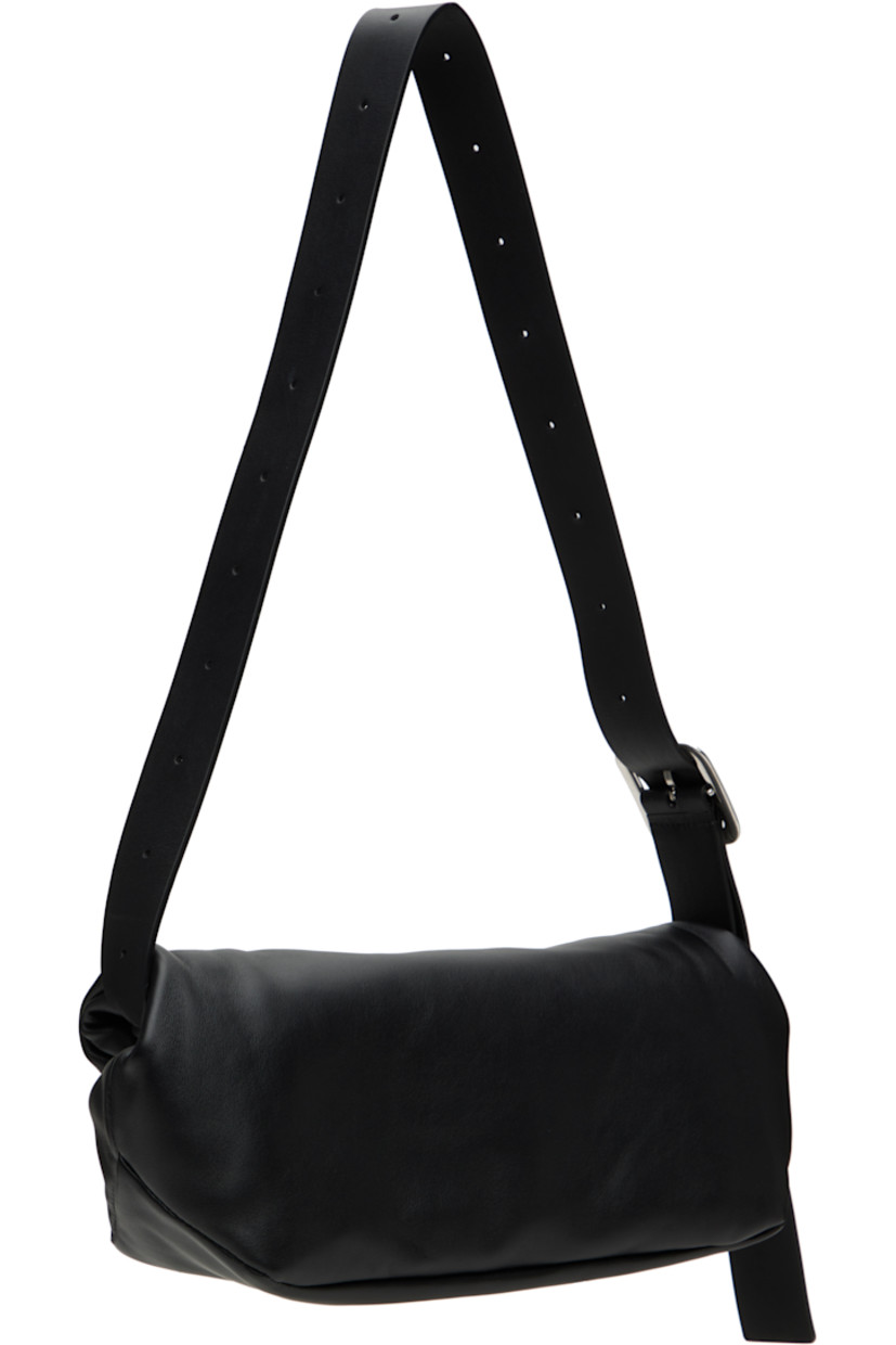 Buffed calfskin belt bag in black.

· Adjustable and detachable crossbody strap
· Logo embossed at face
· Magnetic rolltop closure
· Zip pocket at interior
· Nappa leather lining
· Silver-tone hardware
· H5" x W12.5" x D4"

Supplier color: Black
