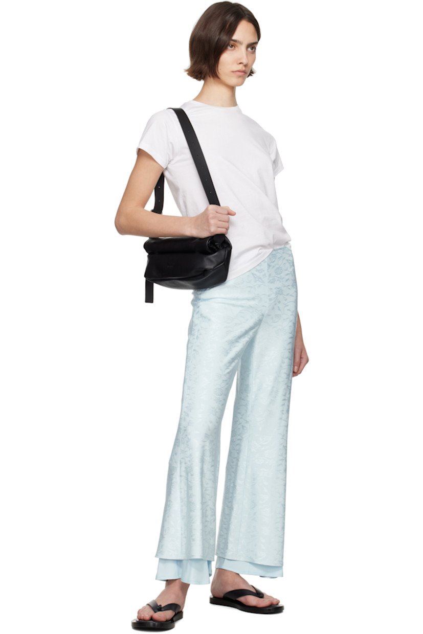 Buffed calfskin belt bag in black.

· Adjustable and detachable crossbody strap
· Logo embossed at face
· Magnetic rolltop closure
· Zip pocket at interior
· Nappa leather lining
· Silver-tone hardware
· H5" x W12.5" x D4"

Supplier color: Black