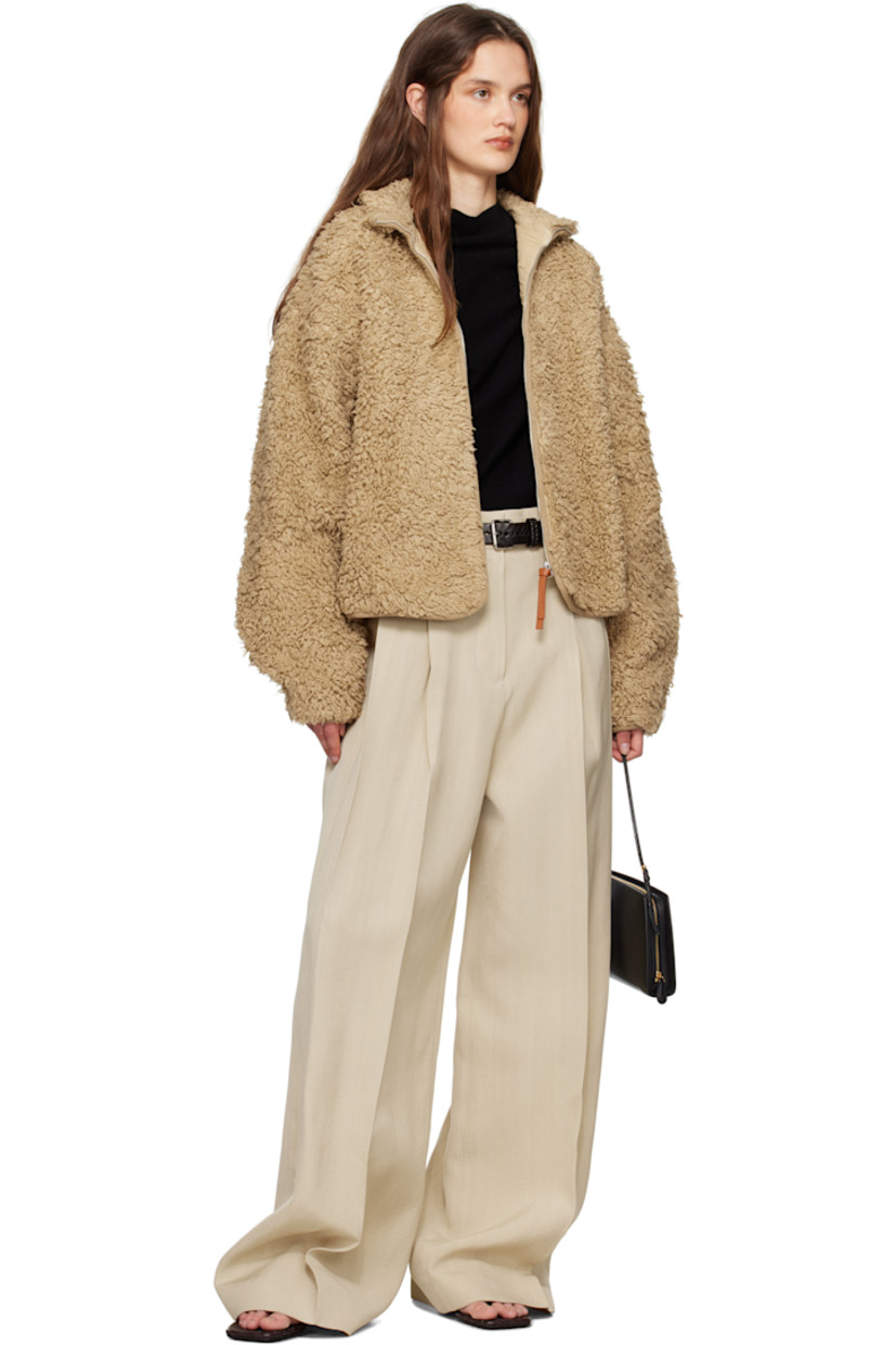 Wide-leg viscose- and silk-blend canvas trousers.

· Belt loops
· Four-pocket styling
· Zip fly
· Pleats at front
· Creased legs
· Unfinished hem
· Partial plain-woven lining

Supplier color: Canvas beige