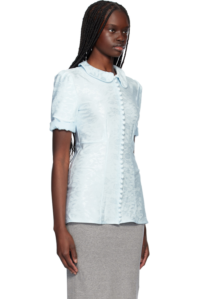 Stretch viscose jersey shirt. Jacquard floral pattern throughout. 

· Peter Pan collar
· Button closure
· Darts at front
· Rolled cuffs
· Partial twill lining

Supplier color: Sky