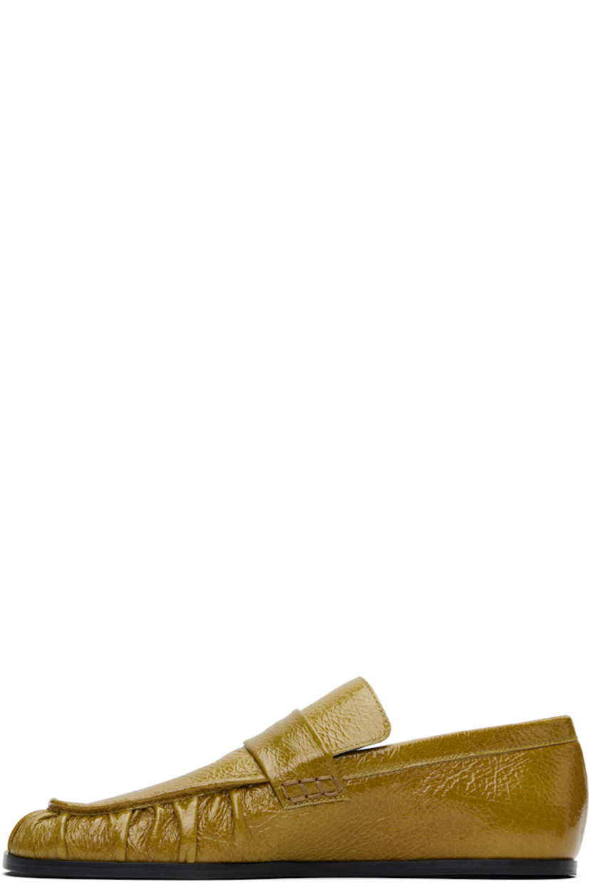 Hand-stitched crinkled patent goatskin loafers in yellow.

· Gathering at square moc toe
· Strap at vamp
· Nappa leather insole and lining
· Polished calfskin sole with rubber injections

Supplier color: Chartreuse