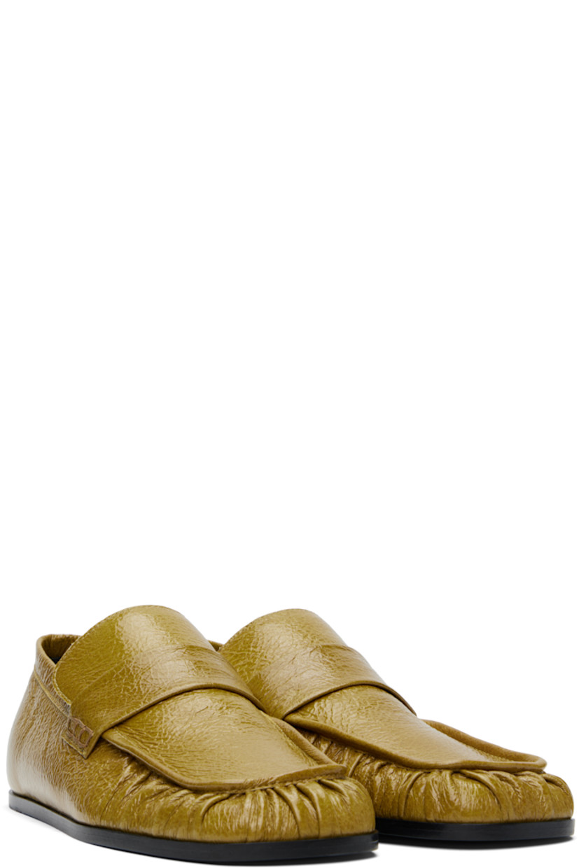 Hand-stitched crinkled patent goatskin loafers in yellow.

· Gathering at square moc toe
· Strap at vamp
· Nappa leather insole and lining
· Polished calfskin sole with rubber injections

Supplier color: Chartreuse