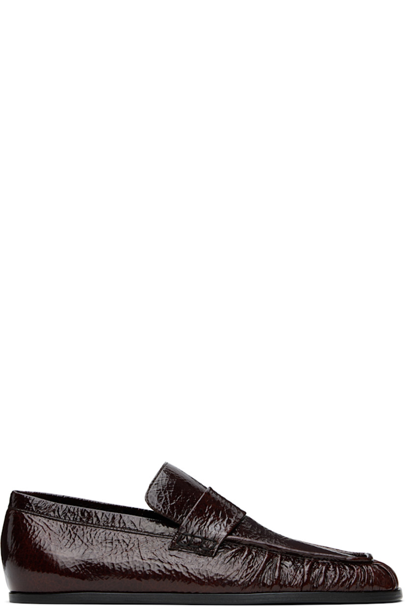 Hand-stitched crinkled patent goatskin loafers in burgundy.

· Gathering at square moc toe
· Strap at vamp
· Nappa leather insole and lining
· Polished calfskin sole with rubber injections

Supplier color: Dark earth
