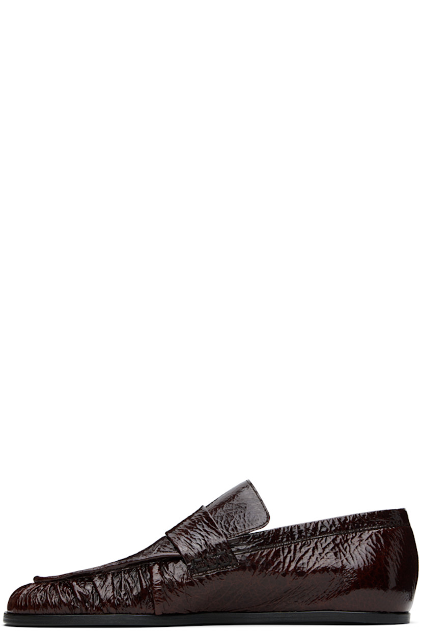 Hand-stitched crinkled patent goatskin loafers in burgundy.

· Gathering at square moc toe
· Strap at vamp
· Nappa leather insole and lining
· Polished calfskin sole with rubber injections

Supplier color: Dark earth