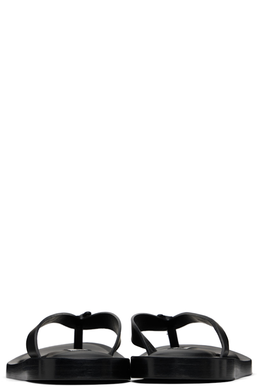 Buffed calfskin flat sandals in black.

· Thong-style strap at open toe
· Logo patch at padded footbed
· Stacked leather midsole
· Leather sole with rubber injections

Supplier color: Black