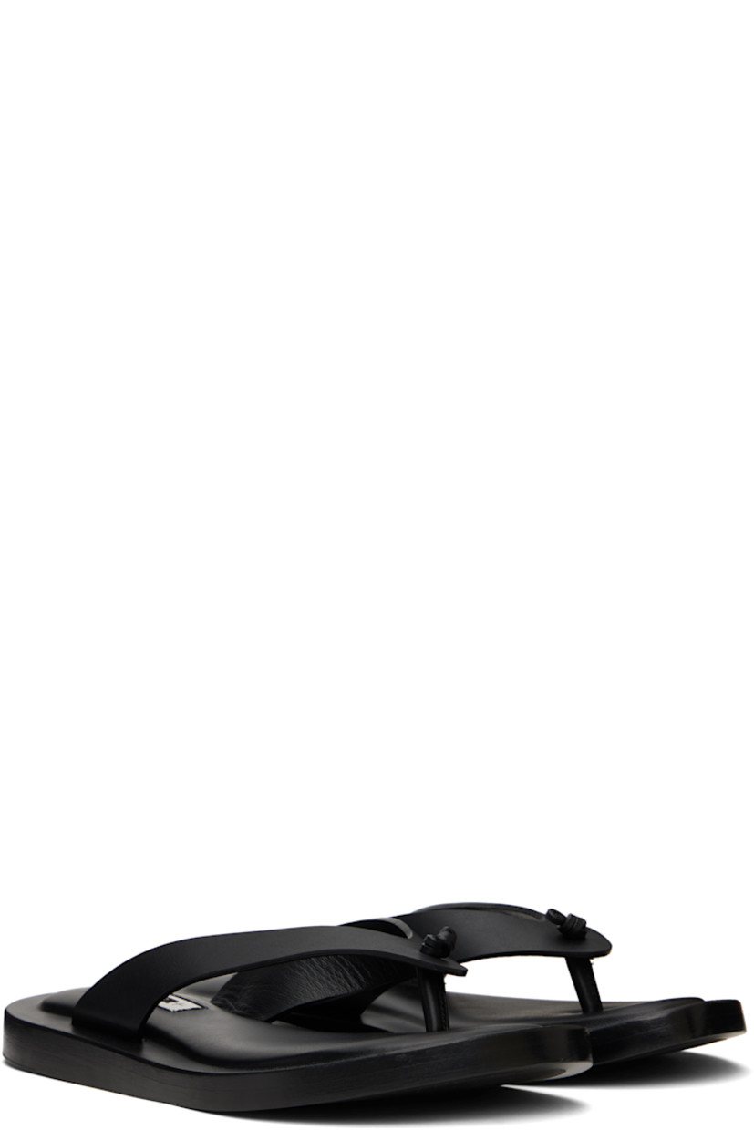 Buffed calfskin flat sandals in black.

· Thong-style strap at open toe
· Logo patch at padded footbed
· Stacked leather midsole
· Leather sole with rubber injections

Supplier color: Black