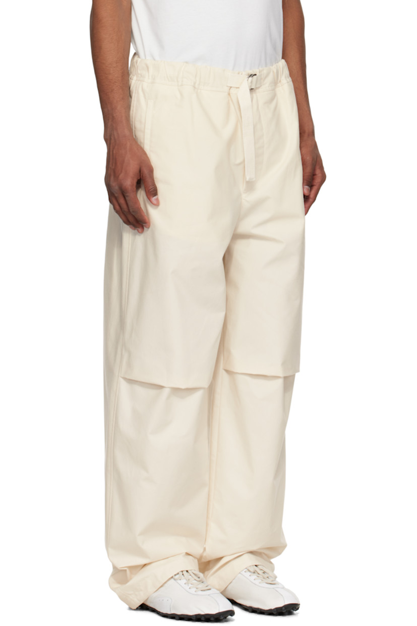 Peached cotton twill trousers.

· Water-repellent
· Integrated cinch belt at partially elasticized waistband
· Four-pocket styling
· Zip fly
· Pleat at knees
· Drawstring at inner cuffs
· Logo embroidered at back

Supplier color: Natural