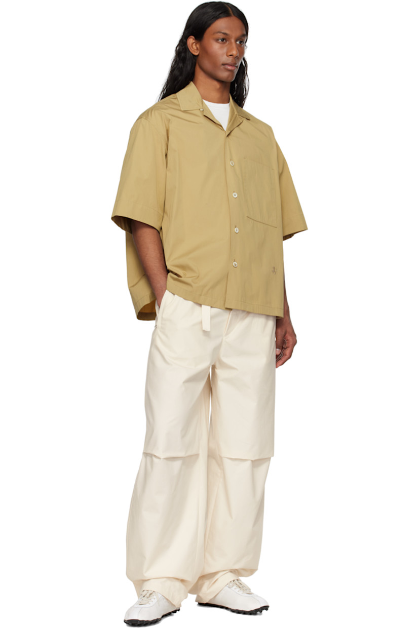 Loose-fit cotton poplin shirt.

· Open spread collar
· Button closure
· Patch pocket
· Logo embroidered at front
· Dropped shoulders
· Horn hardware

Supplier color: Cereal