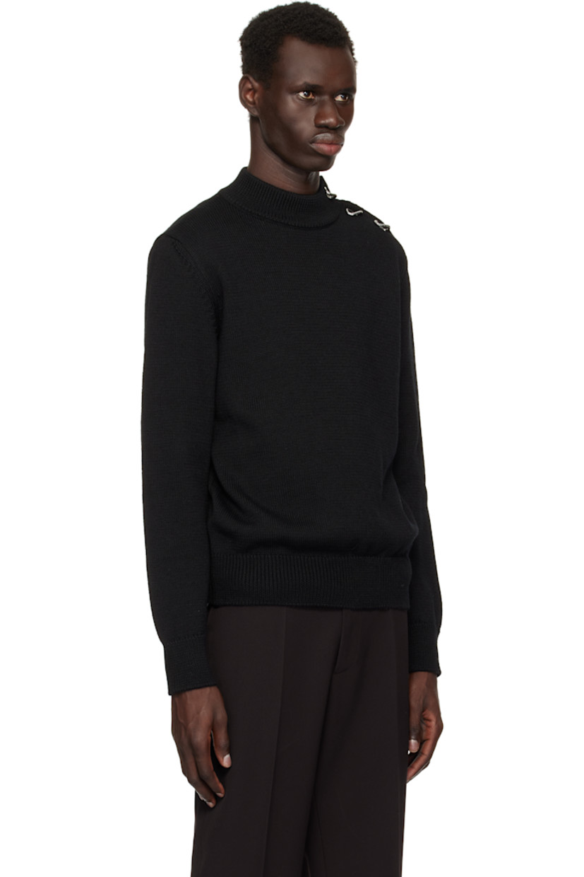 Knit virgin wool sweater.

· Rib-knit mock neck, hem, and cuffs
· Button closure and graphic hardware at shoulder
· Elbow patches
· Silver-tone hardware

Supplier color: Black