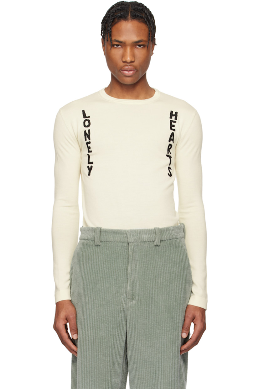 Knit virgin wool sweater.

· Rib-knit crewneck, hem, and cuffs
· Bouclé text appliqués at front 

Supplier color: Cloud
