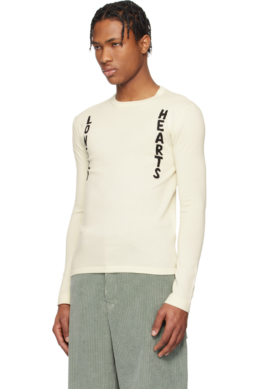 Knit virgin wool sweater.

· Rib-knit crewneck, hem, and cuffs
· Bouclé text appliqués at front 

Supplier color: Cloud