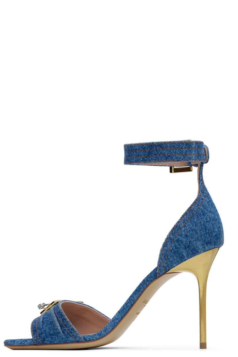 Denim heeled sandals in blue.

· Open square toe
· Logo-engraved graphic hardware at vamp
· Pin-buckle ankle strap
· Logo stamp at padded goatskin footbed
· Buffed calfskin lining
· Metal stiletto heel with rubber injection
· Calfskin sole
· Contrast stitching in tan
· Heel: H3.5"

Supplier color: Blue